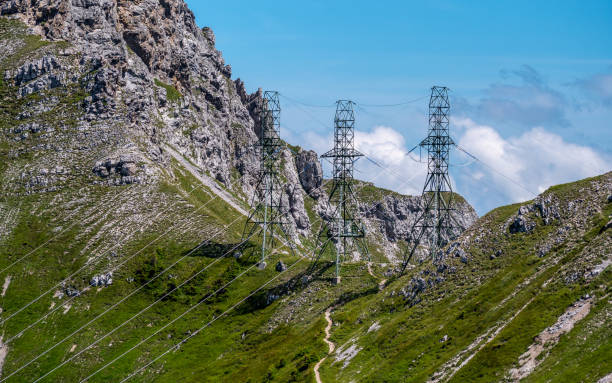 three high voltage post power poles high up in the mountains high voltage tower switzerland alps sunny