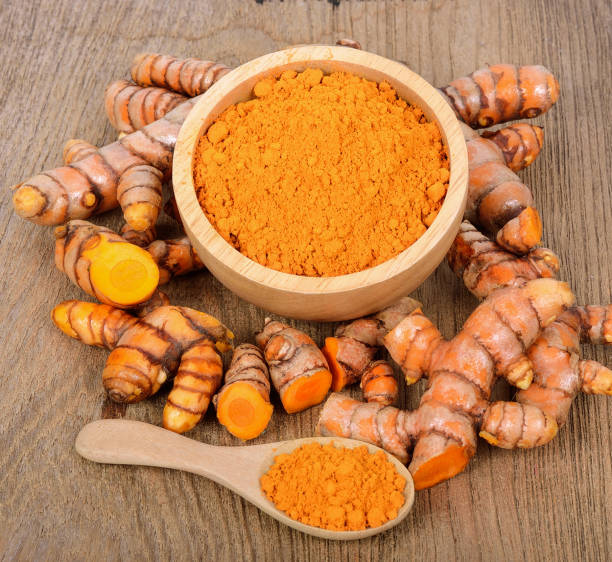 istock turmeric roots on wooden table 1013002516