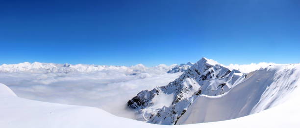 istock Snowy Mountains in the clouds blue sky Caucasus 1013005384