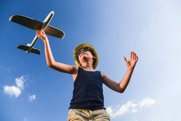 istock teenager playing with a plane 1013009878