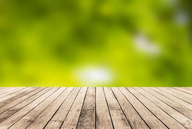 istock Wood plank with abstract green blurred background for product display 1013016160