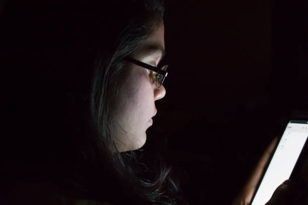istock teenager girl using phone at night 1013023138