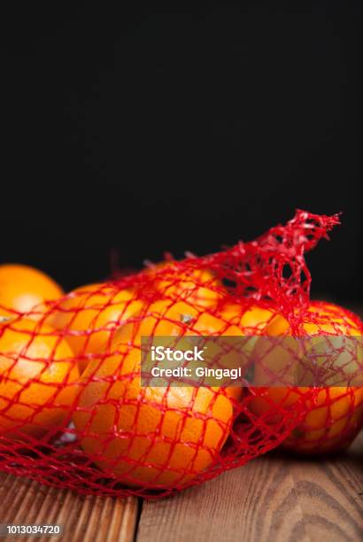 Citrus Fruits Tangerine In Oranges In Plastic Net Bag Package No Plastic Concept Packaging That Does Not Recycle Plastic Rustic Wooden Background Stock Photo - Download Image Now
