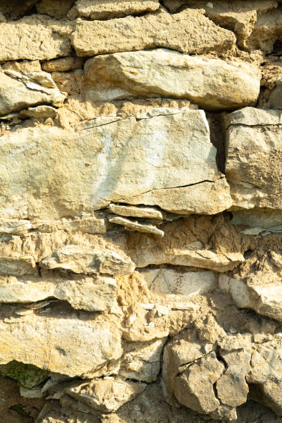 istock Background texture, stone buds, limestone, basalt, cobblestone, granite, pebbles, slate, sandstone laid the wall or in the fence close up for inscriptions or advertisements. 1013039348