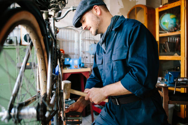 istock hobby mechanic in overall repairs a bicycle in his workshop 1013043094