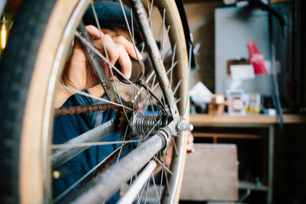 istock hobby mechanic in overall repairs a bicycle in his workshop 1013043434