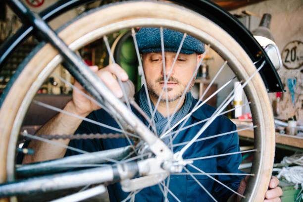 istock hobby mechanic in overall repairs a bicycle in his workshop 1013043454