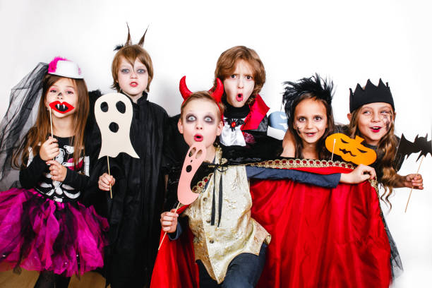 istock Happy brothers and two sisters on Halloween party 1013044320