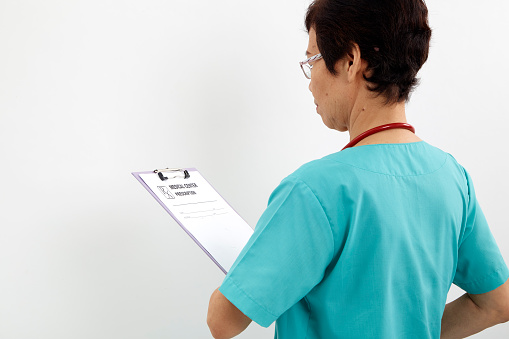 Backside Medical professional with holding clipboard and stethoscope on white background