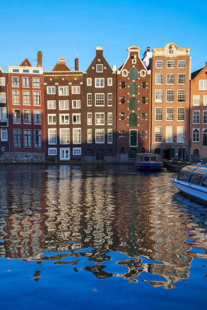 istock Typical Dutch houses built by the canal, Amsterdam, Netherlands 1013050100
