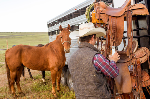 young cowboy preparing horse at santaquin valley of Salt lake City SLC Utah USA