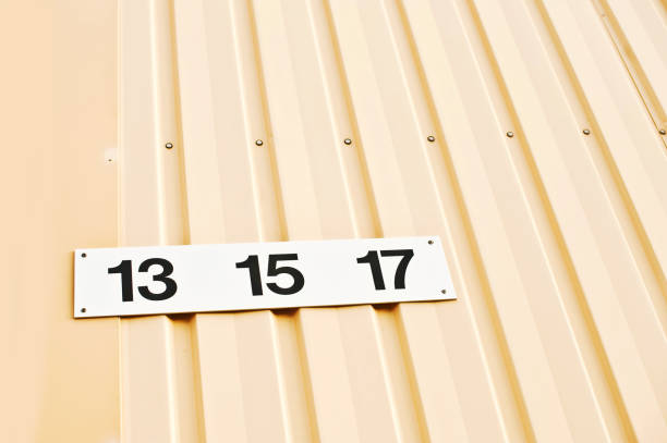 istock House Number 13, 15 & 17 Tag On Yellow Wall 1013058438