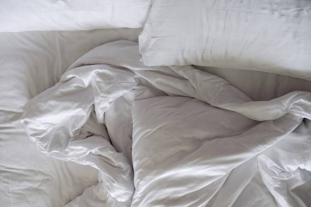istock Messy Bed. White Pillow and Blanket in Bedroom, Relaxation and Comfortable Concept 1013058662