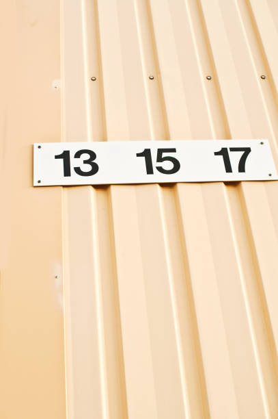 istock House Number 13, 15 & 17 Tag On Yellow Wall 1013058908