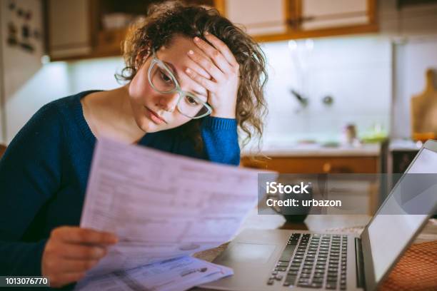 Woman Going Through Bills Looking Worried Stock Photo - Download Image Now - Financial Bill, Currency, Worried