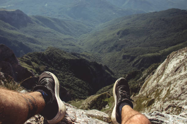 Picture taken as a point of view on a high mountain peek looking far into the distance into layers of mountains.