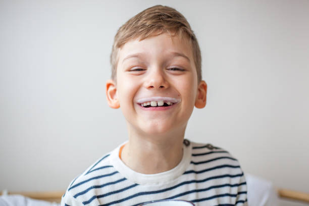 portrait of smiling caucasian boy with milk mustache - milk mustache imagens e fotografias de stock