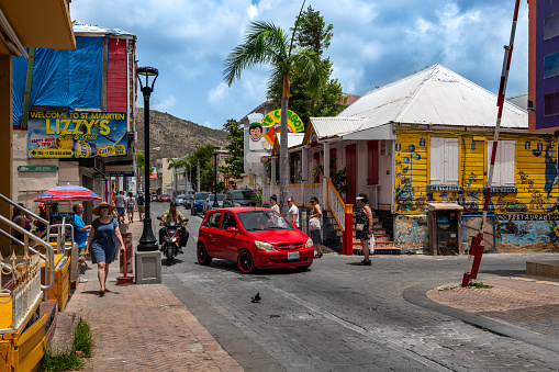 Phillipsburg, St Marteen - July 11, 2018:  A colorful street scene with tourists and colorful architecture along the main street in Phillipsburg, St. Marteen.