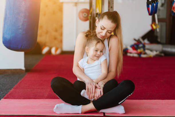 istock Mom and daughter together perform different exercises 1013100606