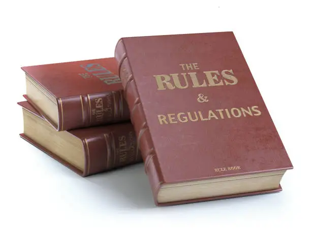 Photo of Rules and regulations books with official instructions and directions of organization or team isolated on white background.