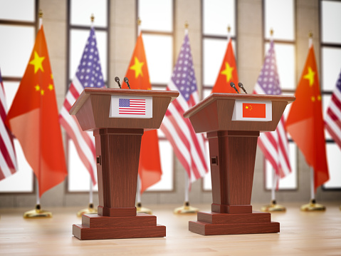 Flags of the USA and China and tribunes at international meeting or conference. Relationship between China and USA concept. 3d illustration