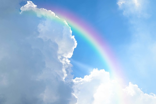Cloudscape rainbow of natural sky with blue sky and white clouds and colorful rainbow in the sky use for wallpaper background