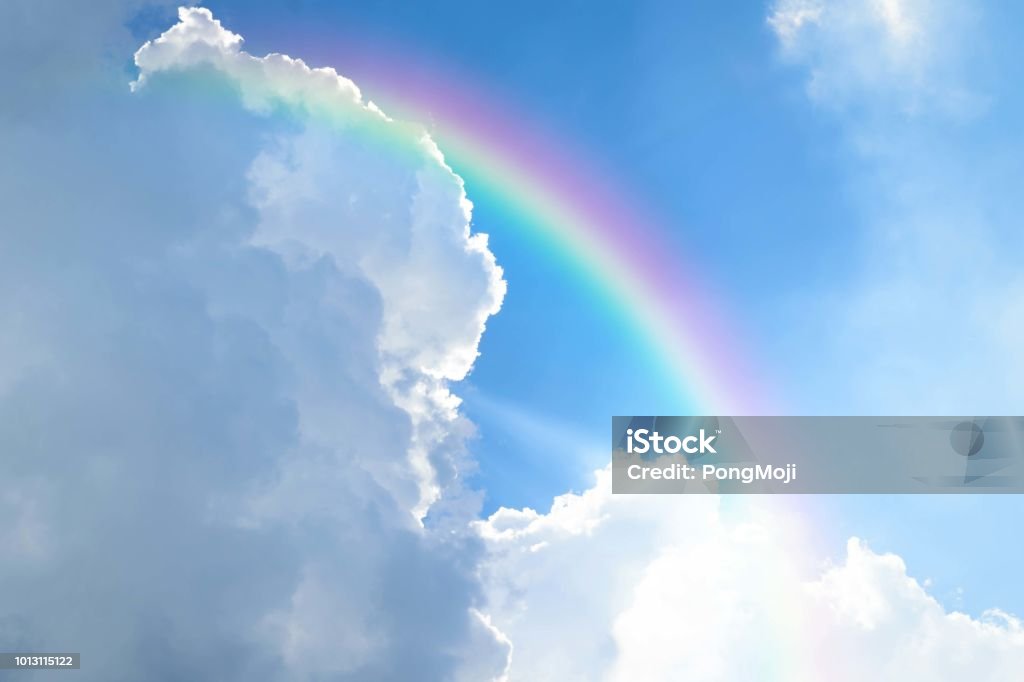 Cloudscape with blue sky and white clouds rainbow Cloudscape rainbow of natural sky with blue sky and white clouds and colorful rainbow in the sky use for wallpaper background Rainbow Stock Photo