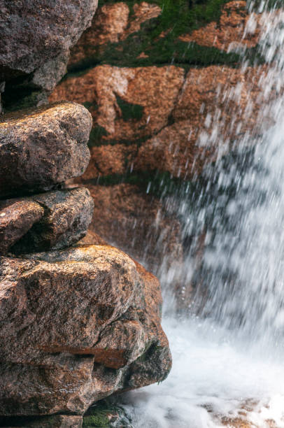 istock Granite outcrop wet with falling water 1013115664