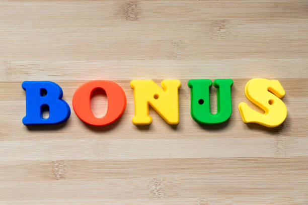 istock Color plastic alphabet in word bonus on wood background 1013125524