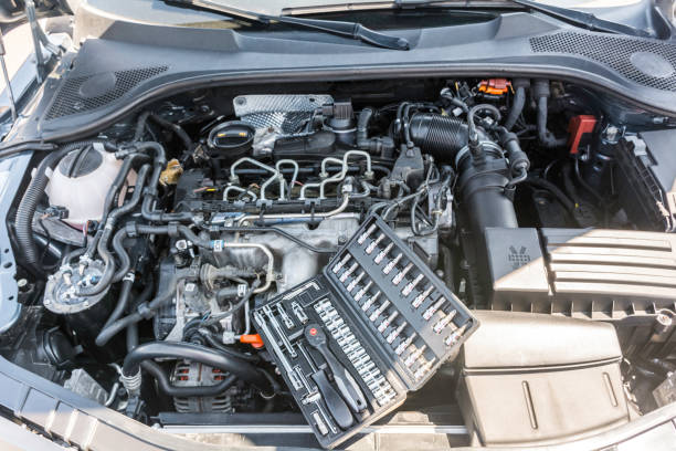 istock Top vertical view of car engine bay and open tool box with specialized tools like gedore and torx. 1013125738