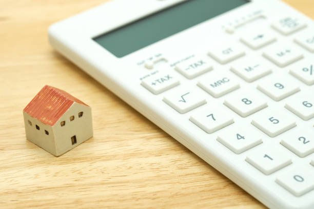 istock A model house model is placed on a calculator. as background property real estate concept with copy space for your text or  design. 1013126516