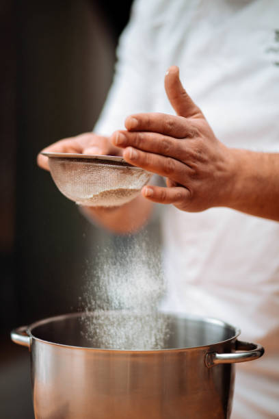 istock Men's hands chef sift the flour 1013133150