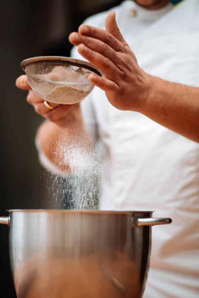 istock Men's hands chef sift the flour 1013133186
