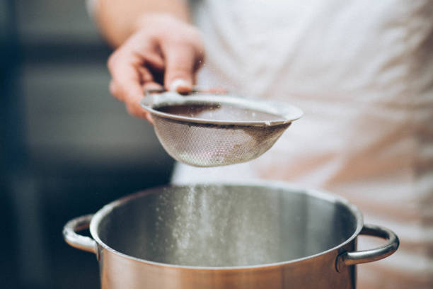 istock Men's hands chef sift the flour 1013133236