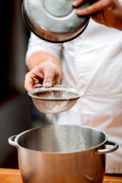 istock Men's hands chef sift the flour 1013133310