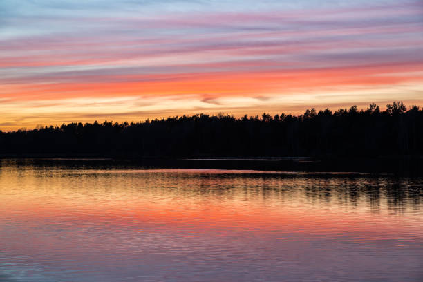 istock Orange and red sunset mirroring in the water 1013140368