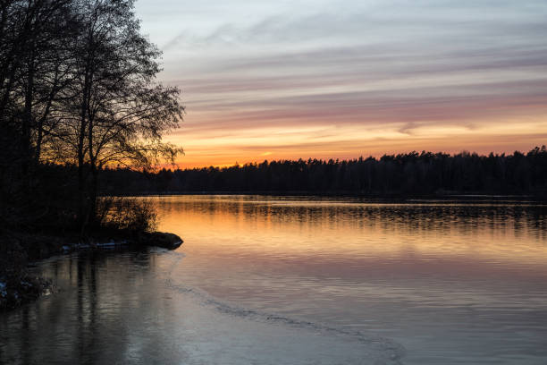 istock Orange and red sunset mirroring in the water 1013140422