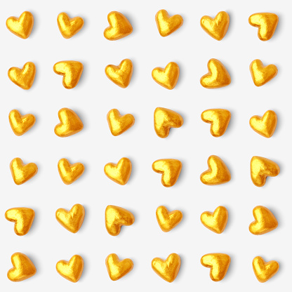 A collection of golden hearts. Beautiful stylish and modern design of small hearts in a row isolated on white piece of paper. 
Hearts resemble luxury chocolates packed in golden tin foil papers.
Hand-made realistic illustration in vector. 
Zoom to see the details. 
Original stylish design associated with opulence, wealth and luxury. Artwork full of depth, glamor and glow. Isolated design object.