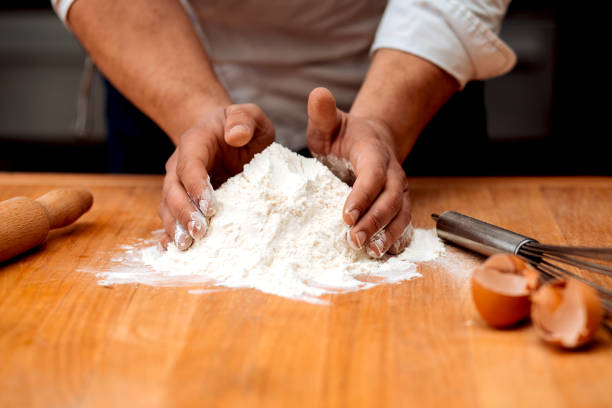 istock Men's hands chef sift the flour 1013146968