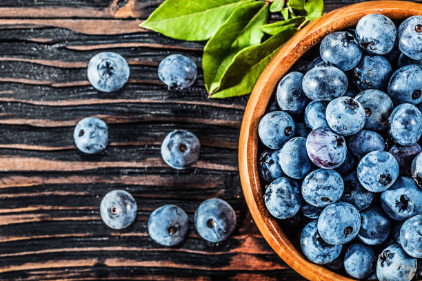 istock Juicy blueberries in wooden bowl 1013159102