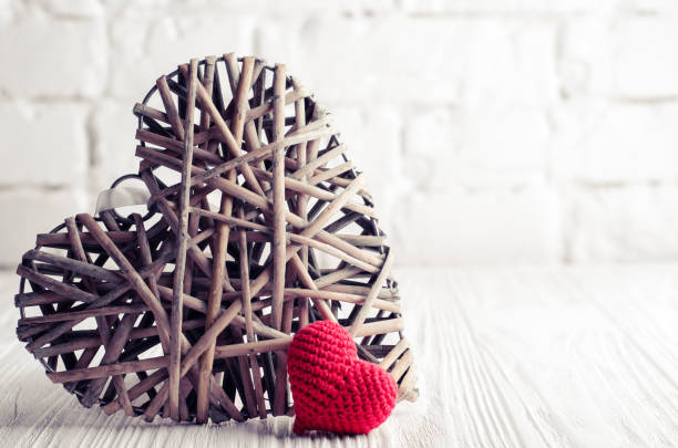 istock Heart shape decorations and gift box on a white brick wall background. Valentines day, Christmas and New year holiday concept 1013171876