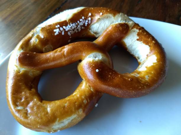 istock Typical German pretzel on a white plate - Southern German specialty 1013172328