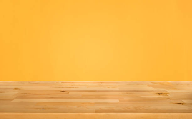 istock Empty wood table top on yellow color background 1013172900