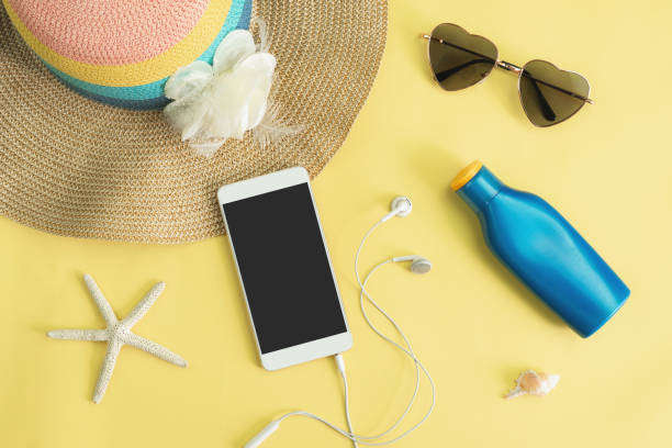 istock Women's accessories items with smart phone on yellow background, Summer vacation concept 1013172906