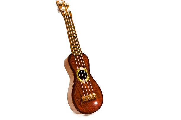 istock The small toy guitar isolated on a white background. 1013188756