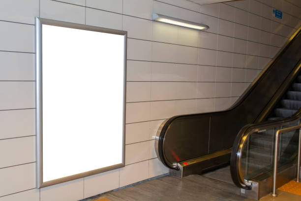 istock One big vertical / portrait orientation blank billboard with escalator background in public transport 1013201604