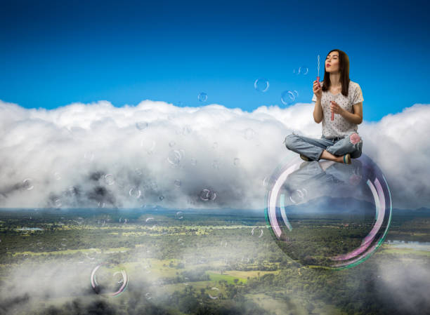 istock Cute woman flying in the sky on big soap bubble 1013204732