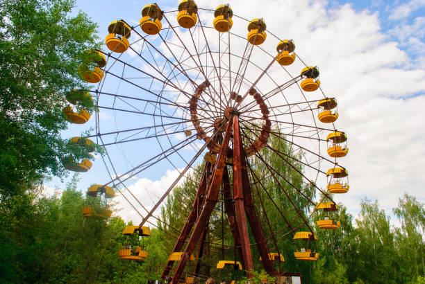 istock Observation wheel carousel with yellow cabins in the former musement park in Pripyat, a ghost town in northern Ukraine, evacuated the day after the Chernobyl disaster on April 26, 1986 1013208468