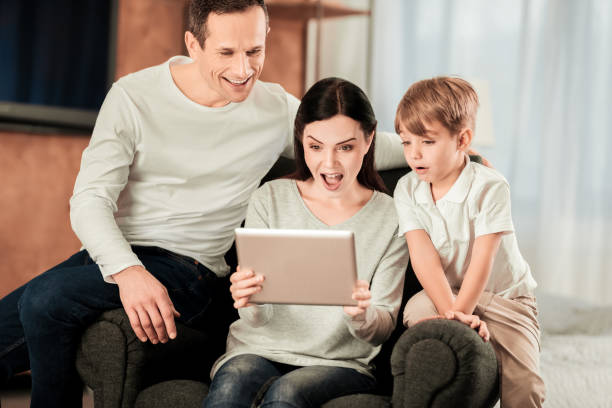 istock Nice surprised family looking at the tablet screen 1013216156