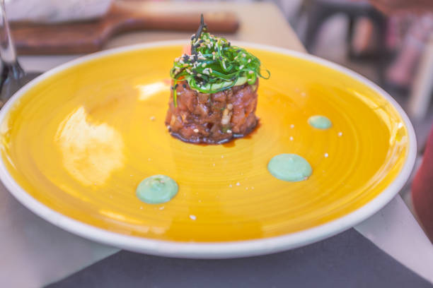 istock tuna tartare on a round orange plate 1013219326